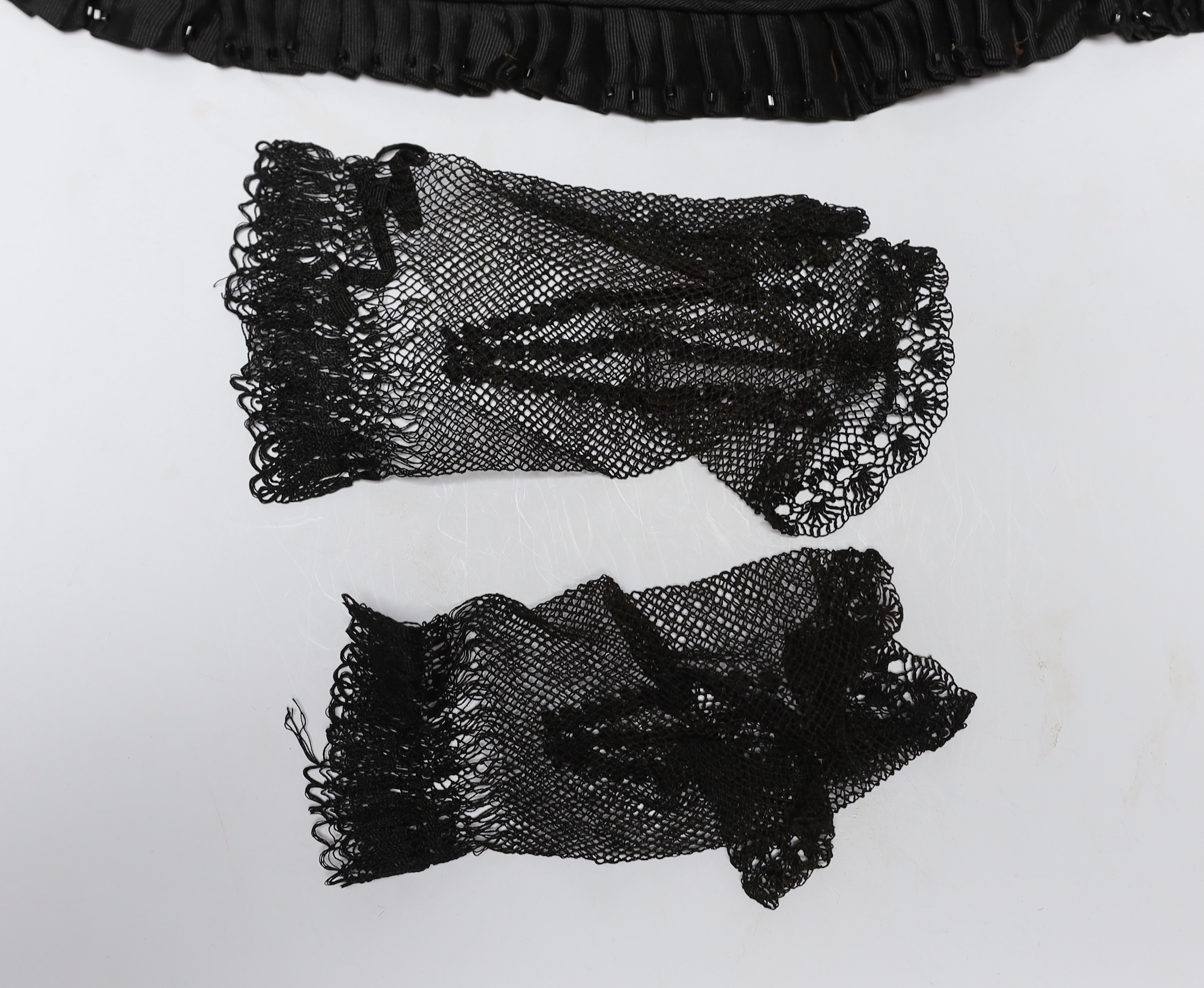 Two 19th century silk baby gowns, a ladies lace trimmed bonnet, a black satin and lace maids apron, various tatting tape lace and other table mats, etc.